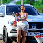 All smiles and gratitude: Ugandan singer Gloria Buggie poses with her latest win, a Mercedes-Benz Bluetec worth over UGX 100M.