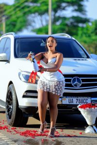 All smiles and gratitude: Ugandan singer Gloria Buggie poses with her latest win, a Mercedes-Benz Bluetec worth over UGX 100M.