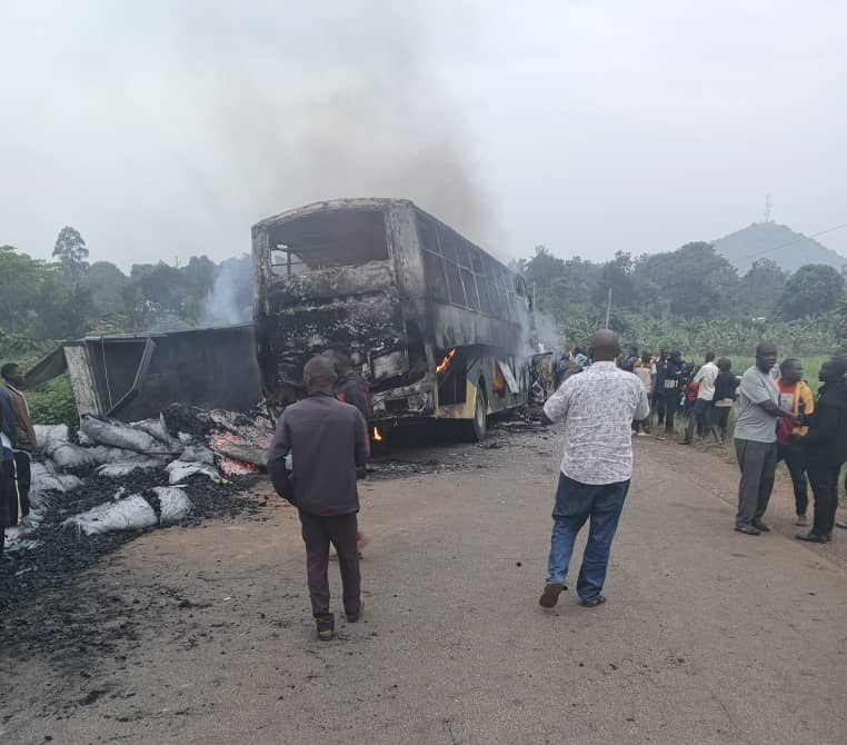 Burnt wreckage of an Isuzu bus and Fuso Fighter truck after a fatal head-on collision along Hoima–Kiboga Road in Kyankwanzi.