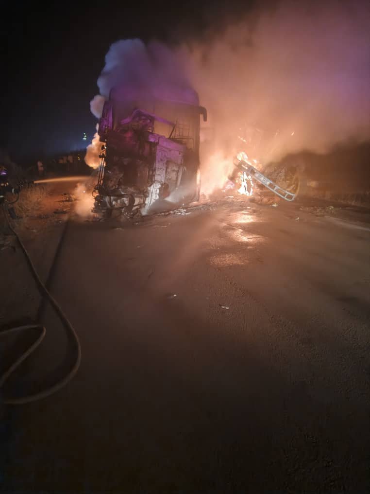Burnt wreckage of an Isuzu bus and Fuso Fighter truck after a fatal head-on collision along Hoima–Kiboga Road in Kyankwanzi.