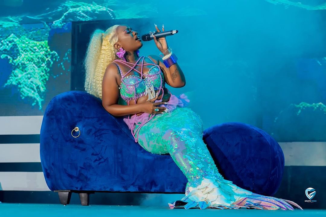 Lydia Jazmine performing live on stage during her First Born concert at Hotel Africana in Kampala.