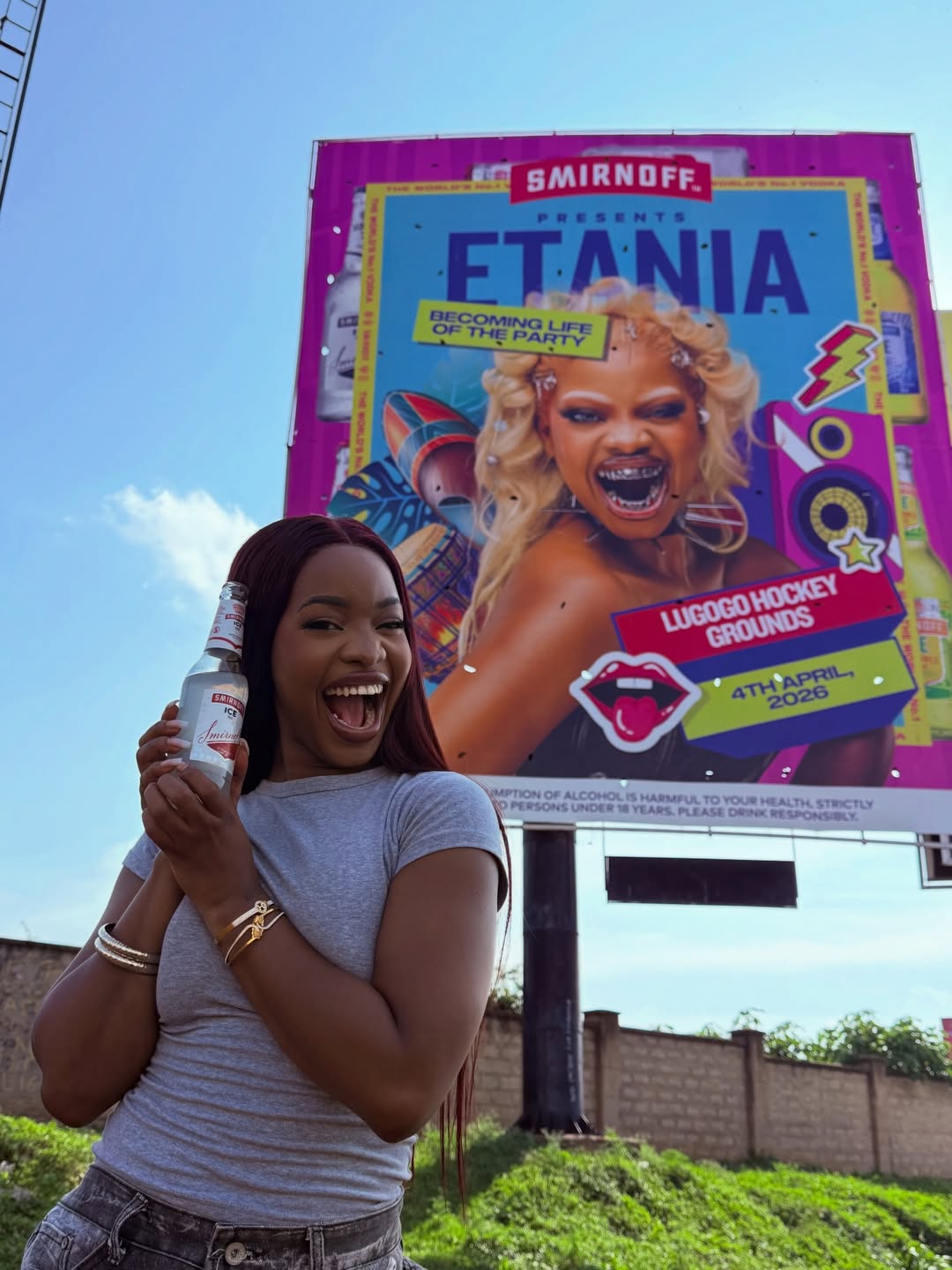 Etania standing beside her concert billboard promoting her Lugogo Hockey Grounds headline show
