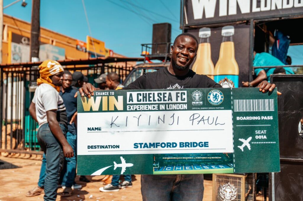 Kiyinji Paul from Nyendo, Masaka, celebrates after winning a trip to London to watch Chelsea FC live at Stamford Bridge.