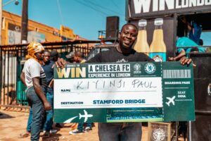 Kiyinji Paul from Nyendo, Masaka, celebrates after winning a trip to London to watch Chelsea FC live at Stamford Bridge.